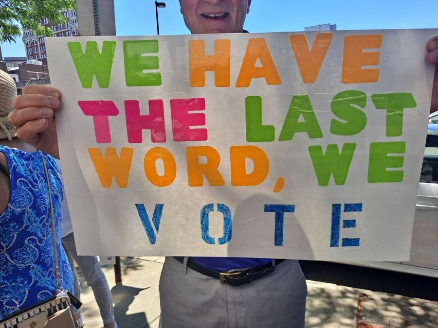 Members with signs at a community action